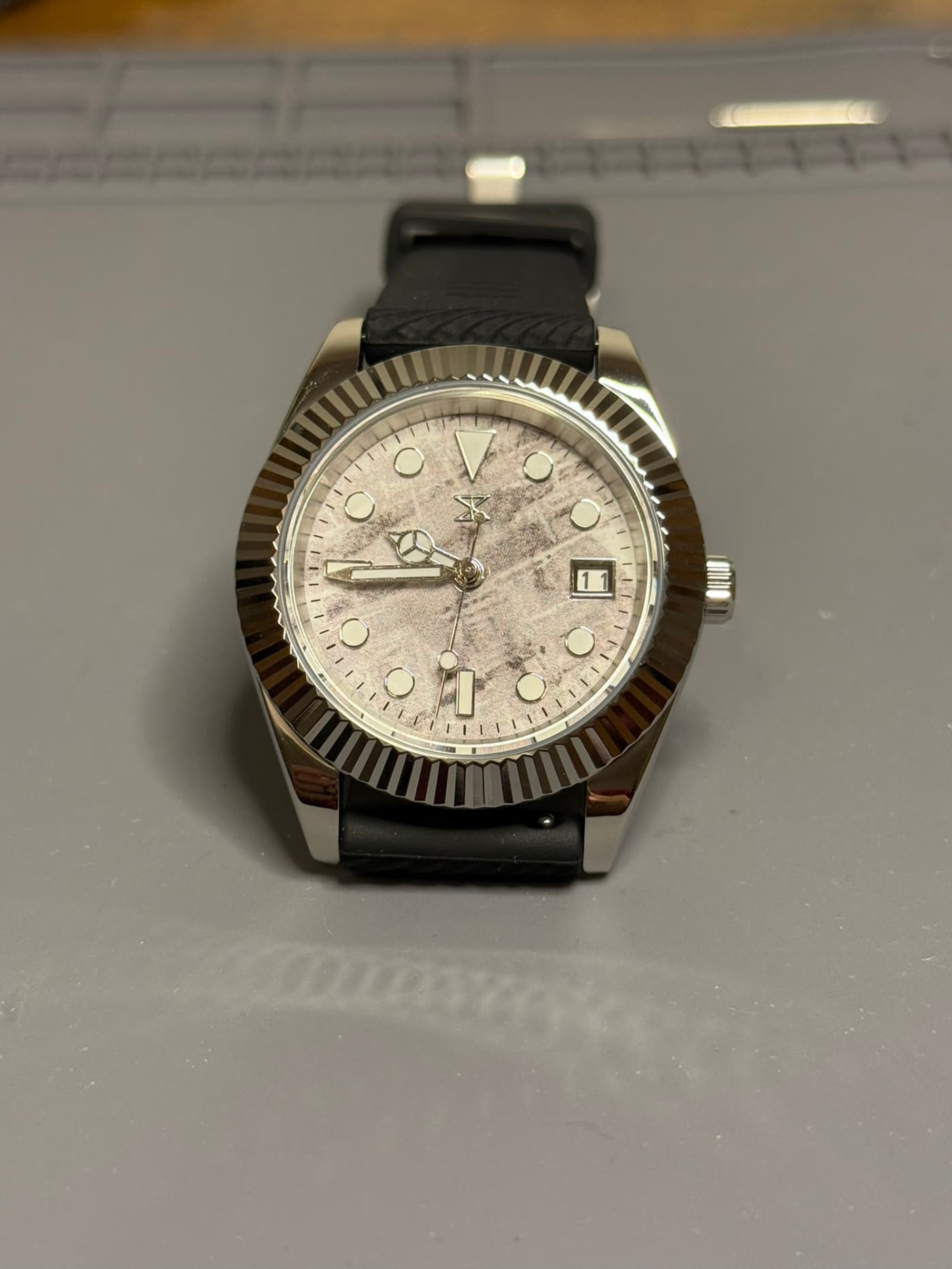 Textured stone dial with fluted bezel, dial face on